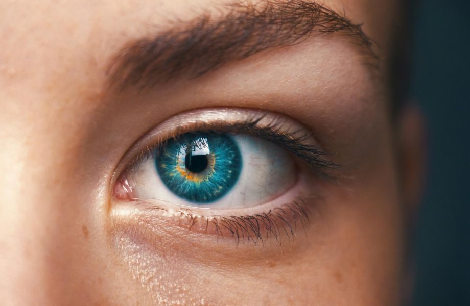 Close-up of a blue eye with detailed iris, representing vision and eye health.