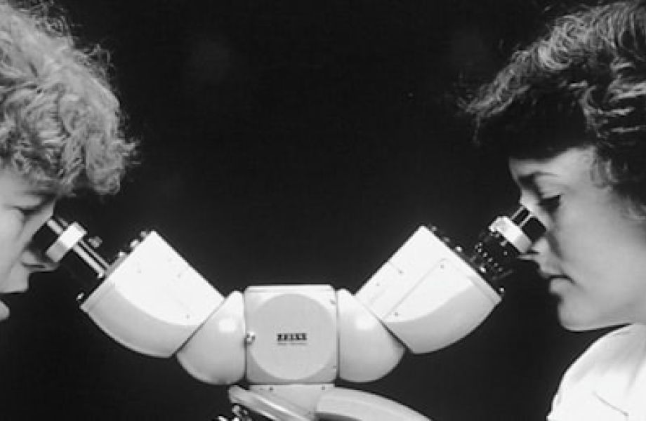 doctors looking through a microscope analyzing MIGS procedures