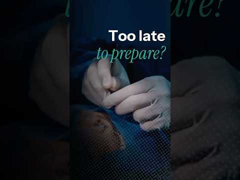 Close-up of a surgeon's gloved hands preparing for cataract surgery