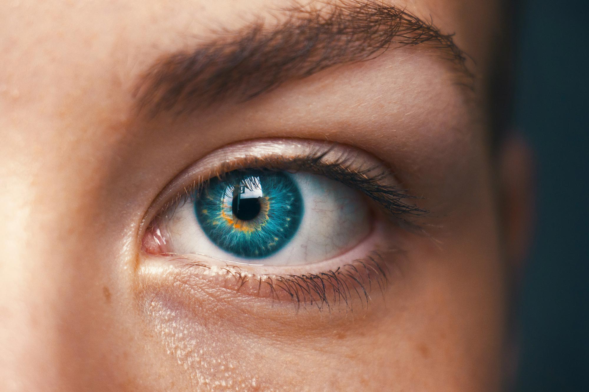 Close-up of a blue eye with detailed iris, representing vision and eye health.