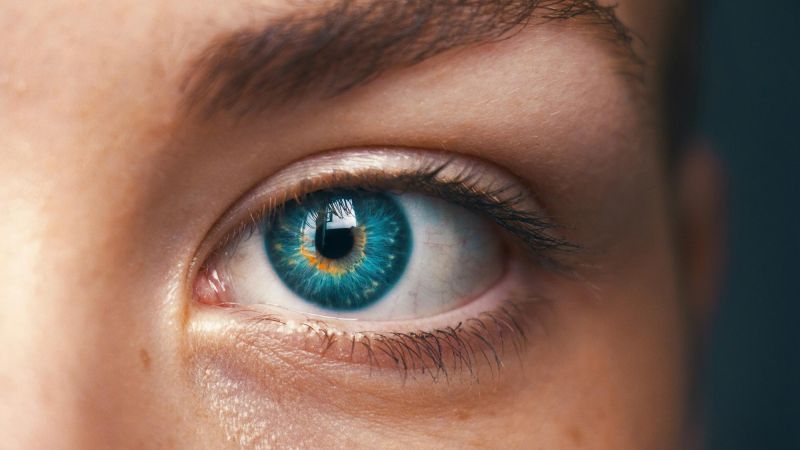 Close-up of a blue eye with detailed iris, representing vision and eye health.