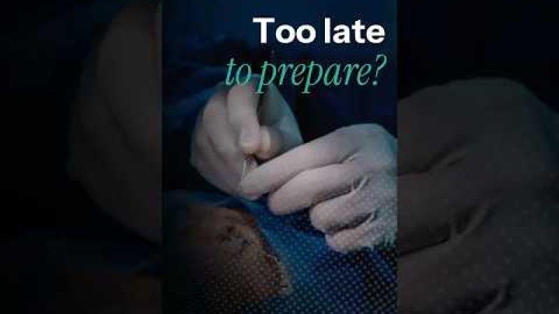 Close-up of a surgeon's gloved hands preparing for cataract surgery